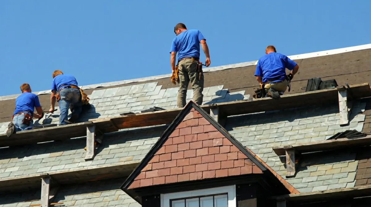 Roof replacement in progress with a team of professional contractors installing new shingles on a residential home in Salt Lake City, UT